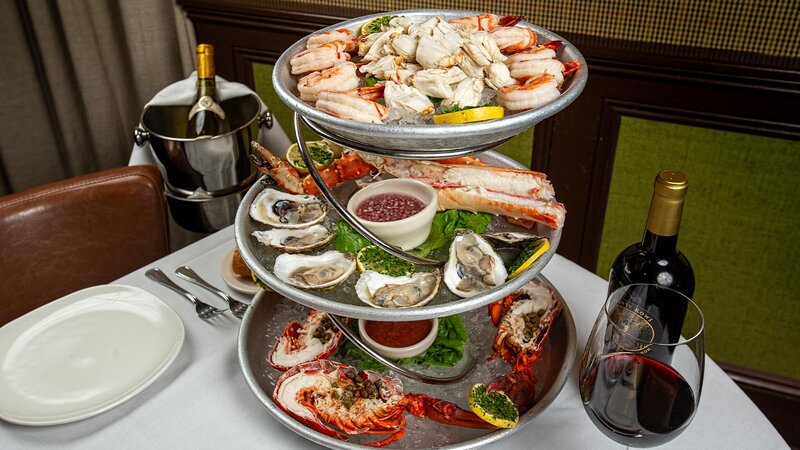 Closeup of raw bar tower and red wine